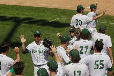 Sac State outfielders junior Matt Smith (left) and senior Bronson Grubbs (right) high-five teammates upon returning to the dugout in a 5-4 win Sunday over CSU Bakersfield at John Smith Field. Since beginning the season 3-6, the Hornets have gone 18-4 and are currently first in the Western Athletic Conference.