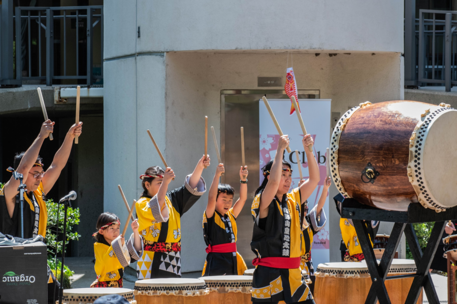 The Koyasan Spirit of Children Taiko Group strike taikos in unison during a performance for Sac States Japan Day. Each taiko is unique and custom-made from sanded wine barrels.