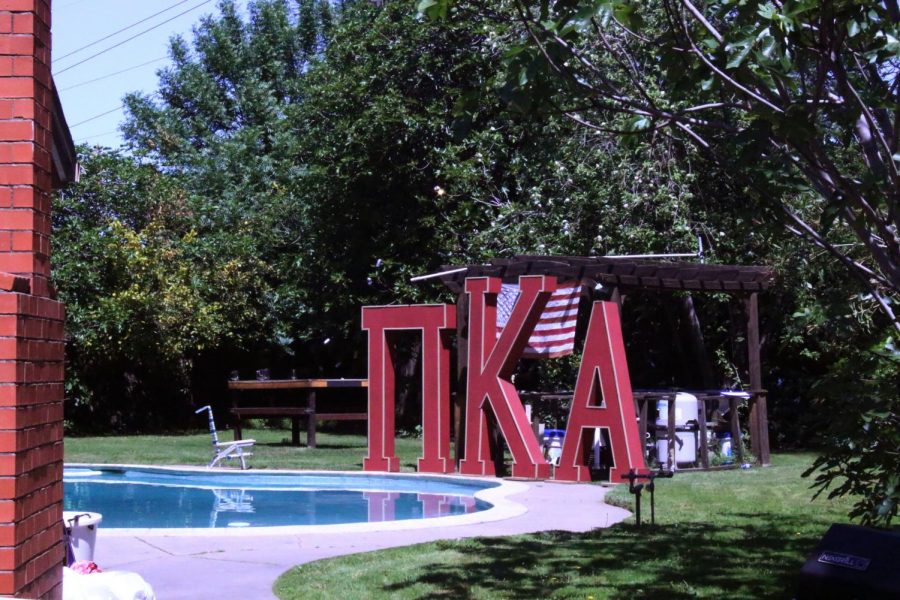 Large Greek letters are visible next to a backyard pool over the fence of the home where 21-year-old Sac State business major and Pi Kappa Alpha member William Molina died after being shot by a pellet gun Friday, April 12. Members of the university's chapter refer to the home as 'The Fratican.'