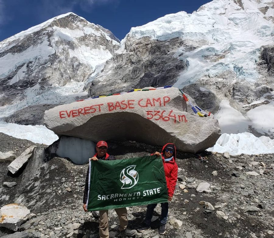 Joe Dangtran and Vijay, an Everest porter, hold a Sac State flag at the Mount Everest South Base Camp. Dangtran, a former Sac State student, said he took the flag with him as a personal thank you to the professors that helped him transfer to Northeastern University.