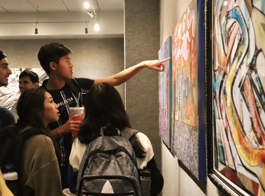 Sac State students observe the graffiti-themed artwork of Drew Ochwat, whose work is being showcased in the University Union. The gallery will be open until Oct. 17.