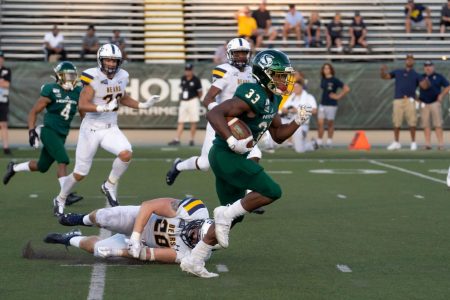 Sac State junior running back Elijah Dotson runs over the Bears defense against Northern Colorado on Saturday, Sept. 14 at Hornet Stadium. Dotson had a total of 158 yards receiving and one touchdown in the win.