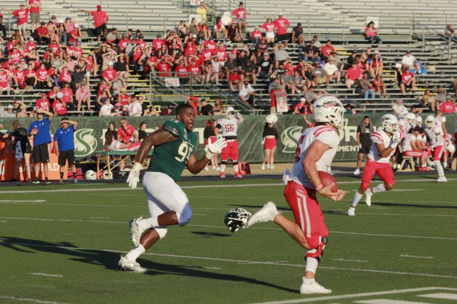 Sac State senior defensive lineman Dariyn Choates sprints after the Raiders quarterback after his helmet falls off against Southern Oregon on Saturday, August 31 at Hornet Stadium. The Hornets went on to win the game 77-19 and broke several records.