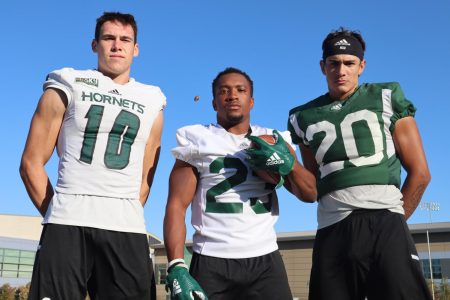 From left, Sac State football players, freshman WR Parker Clayton, senior RB JaNarrick James and sophomore DB Abel Ordaz pose for a photo after practice on Thursday, Sept. 19. All three players were walk-ons and recently earned scholarships.