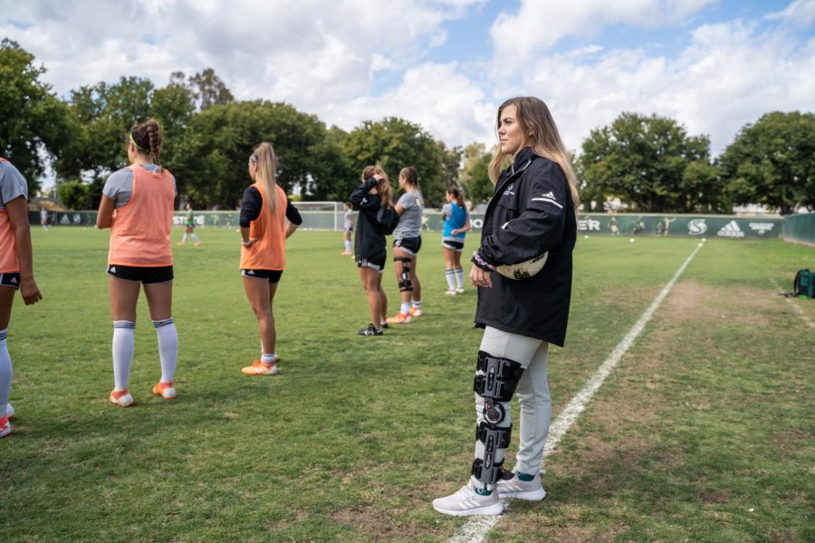 Sac State senior goalkeeper Kaylyn Evans watches her team practice on Wednesday, Sept. 18 at Hornet Field. Evans tore her ACL in the first team practice of her senior year on July 22.