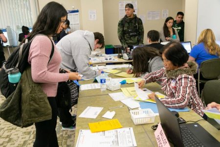 A poll worker assists a voter at the vote center in Modoc Hall Tuesday, Nov. 6, 2018. Assemblymember Ash Kalra credited Sac State for providing a real-world example for the recently signed Assembly Bill 59, which prioritizes the placement of voting centers on college campuses.