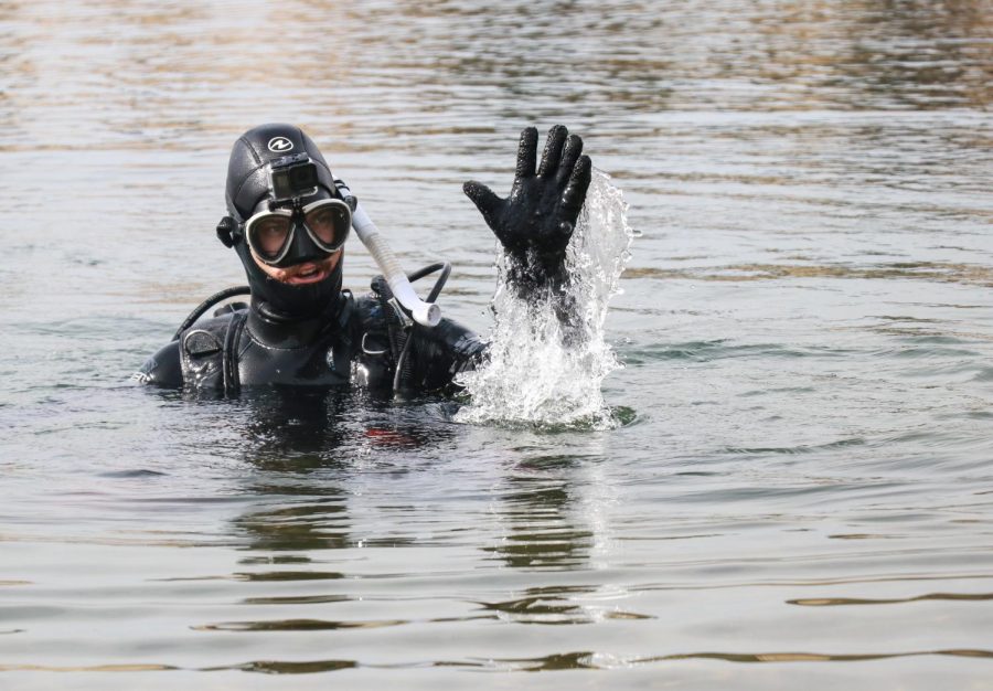 Sac State student Michael Pelley waves to a passersby as he scuba dives at Lake Natoma on Wednesday, Oct 16. “I actually got a picture from a fan that’s a picture of me scuba diving, she ended up drawing it while watching one of my videos,” Pelley said. “It’s the best piece of treasure i’ve gotten so far.”
