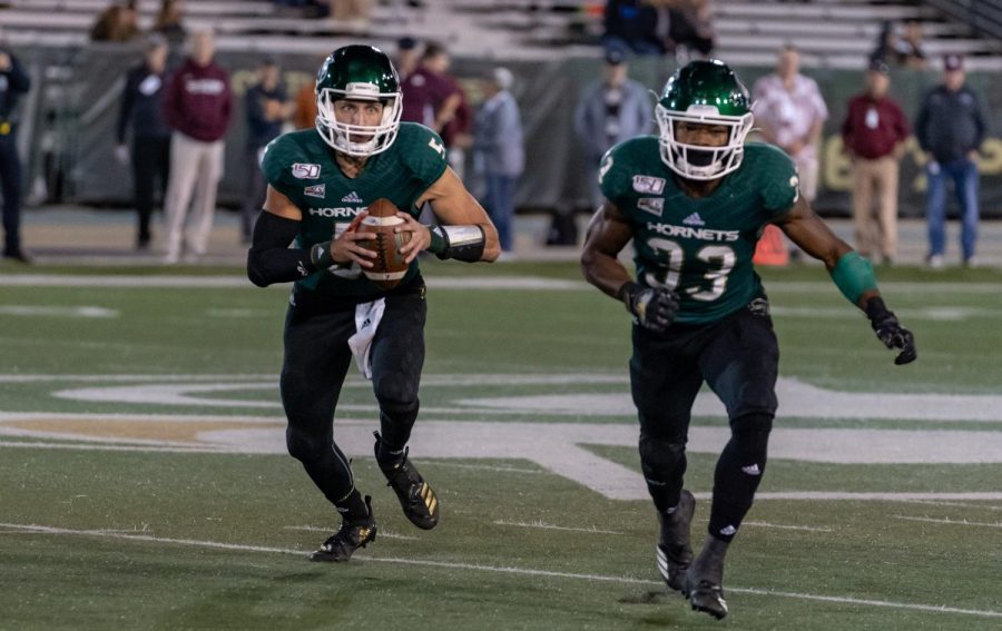 Sacramento State juniors, quarterback Kevin Thomson and running back Elijah Dotson, run an option play against Montana Oct. 19 at Hornet Stadium. The No. 6 Hornets host No. 3 Weber State Saturday night.