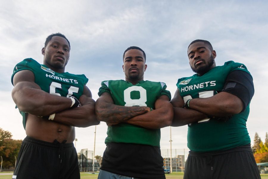 From left to right, Sac State senior football players, defensive lineman George Obinna, defensive back Caelan Barnes and defensive lineman Dariyn Choates pose for a photo after practice. Sac State’s defense has accumulated 38 sacks this season through ten games, the most in the Big Sky.