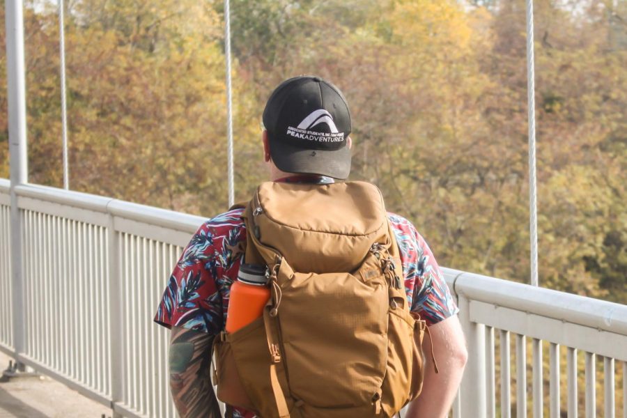 Kyle Murphy, a communication studies major, walking on the Guy West Bridge at Sacramento State. Murphy works with Peak Adventures at the Challenge Center and also serves as a whitewater rafting guide.