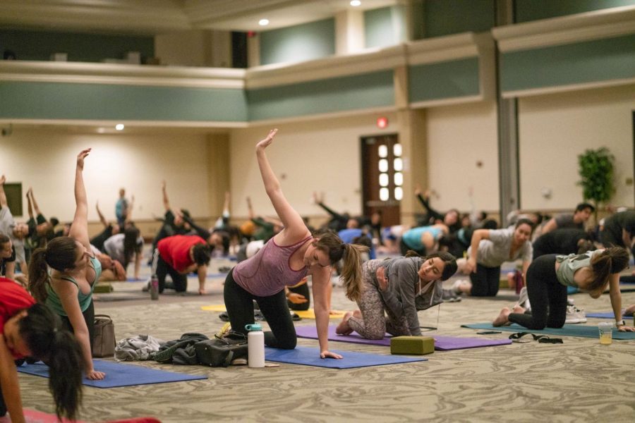 Students stretching during last semester's Yoga Night held Mar. 14, 2019. The free event is designed to give students a set time to destress. Photo Courtesy of Maurqui Burks