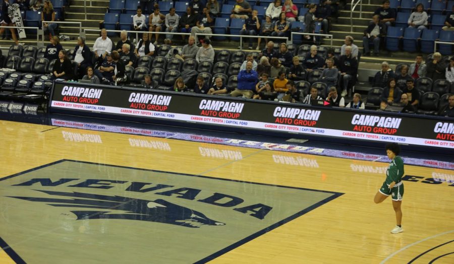 Sac State senior guard Camariah King stretches at midcourt in Lawlor Events Centor on Saturday, Nov. 9 in Reno, Nevada. King played in Reno for her 49th and final time as a collegiate Saturday.