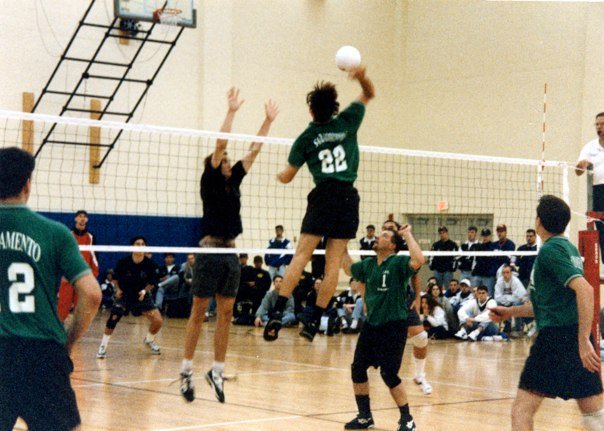 Head volleyball coach Ruben Volta sets the ball to his teammate during a match. Volta played for the Hornets men's club volleyball team for four years (1991-93, 1995).