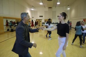 Gymnastics head coach Randy Solorio dances with senior kinesiology major Viktoriya Rizvanova in the ballroom dancing class Solorio teaches at Sacramento State. Solorio has been coaching gymnastics at Sac State since 1986.