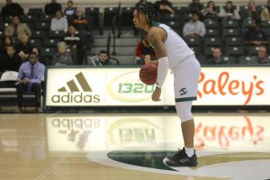 Sac State sophomore guard Brandon Davis dribbles near midcourt and surveys the floor against UC Merced on Tuesday, Dec. 3 at the Nest. Davis had five points and four assists in the win.