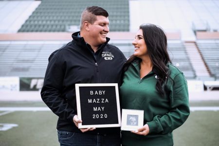 Sac State alumni Nick and Kimberly Mazza take their pregnancy announcement photos Tuesday, Nov. 26 at Hornet Stadium. The couple met as student athletes at Sac State.