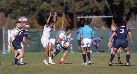 Sac State mens rugby club captain John Joshua Bocalan Reyes safely receives a pass from his teammate during a game. The rugby team qualified to compete in Nationals after their Pacific West Sevens Tournament win.