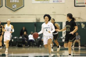 Sac State senior guard Camariah King sprints past Pacific Union senior guard Elissa Root during a game against the Pioneers on Thursday, Dec. 19 at the Nest. The Hornets defeated the Pioneers 94-35.