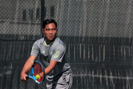 Sac State senior Hermont Legaspi prepares to serve during a doubles match against Washington at Sacramento State Courts on Saturday, Feb. 22. The Hornets lost to Washington 6-1. 