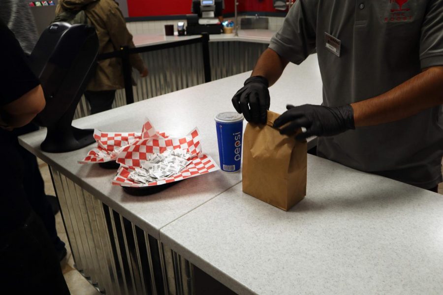 An employee at the Roost in the University Union at Sac State serves food to a customer in September, 2019. The transition to online classes due to coronavirus concerns is forcing some eateries at Sacramento State to cut their hours, or close until further notice.