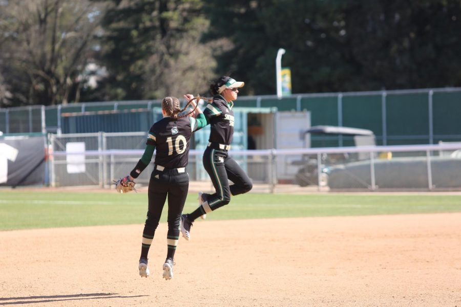 Sac State sophomore shortstop Shea Graves and freshman outfielder Aliyah Robles leap in celebration against UC Santa Barbara at Shea Stadium on Sunday, Feb. 9. Graves and the Hornets had their season canceled due to the COVID-19 pandemic.