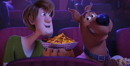 Shaggy Rogers (Will Forte) and Scooby-Doo (Frank Welker) share nachos at a movie theater during the latest addition to the Scooby-Doo franchise, SCOOB! (Photo courtesy of Warner Bros. Entertainment Inc.)