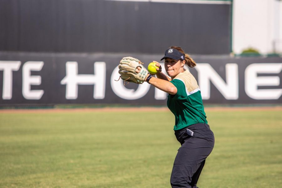 Sac State softball coach Lori Perez throws the ball during practice Wednesday, Oct. 9 at Shea Stadium. Perez said the cancellation of the season was a huge disappointment for her senior athletes.