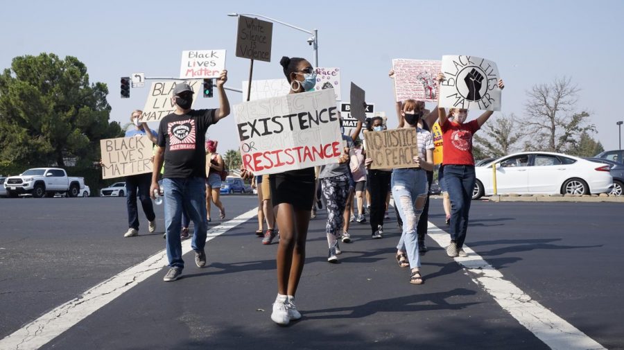 Protestors in Roseville, California march across the street during a Black Live Matter protest organized by Woodcreek High School students Saturday Sept. 5, 2020. It’s become clear that excessive police funding takes away funding from education, city enrichment and other services in low-income communities and in communities of color, said opinion writer Jordan Parker.
