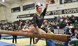 Sac State sophomore Amber Koeth poses on the balance beam during a meet last year at the Nest. Koeth spoke with The State Hornet about her battle with depression. Photo courtesy of Sac State Athletics. 