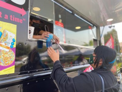 Employee Gisel Rodriguez hands a