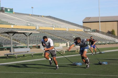 Freshman guard Teiano Hardee and freshman forward David Jones racing with tied weights. Sophmore Guard Jalen Townsell trails behind them.