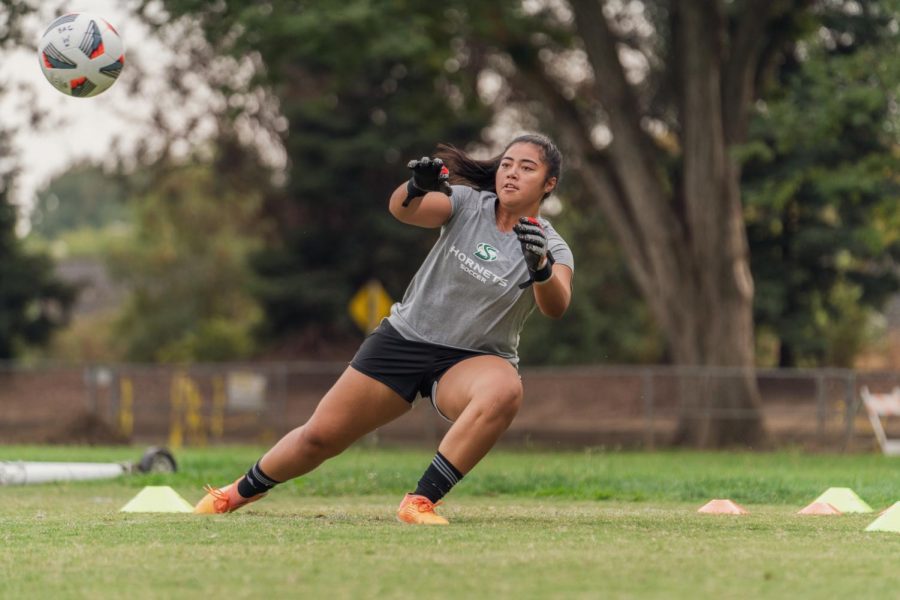 Aaliyah Fesili, goalkeeper for Sac States womens soccer team, warms up with head coach Randy Dedini at a socially distanced practice on Thursday Oct 8th, 2020. Fesili earned Goalie Of The Year in the Big Sky Conference last season.