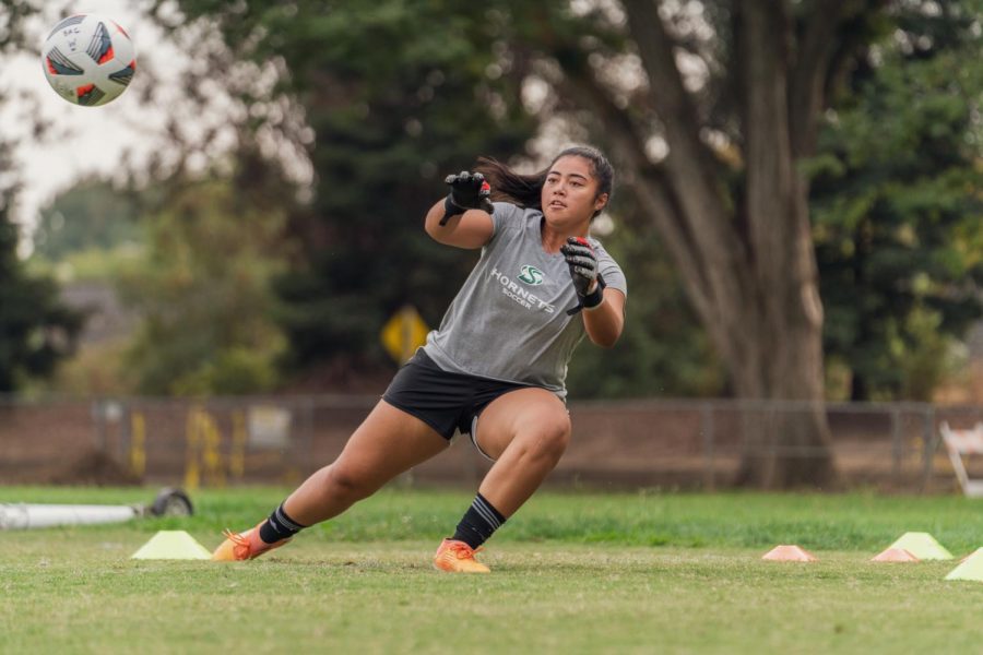 Aaliyah Fesili, goalkeeper for Sac State's women's soccer team, warms up with head coach Randy Dedini at a socially distanced practice on Thursday Oct 8th, 2020. Fesili earned Goalie Of The Year in the Big Sky Conference last season.