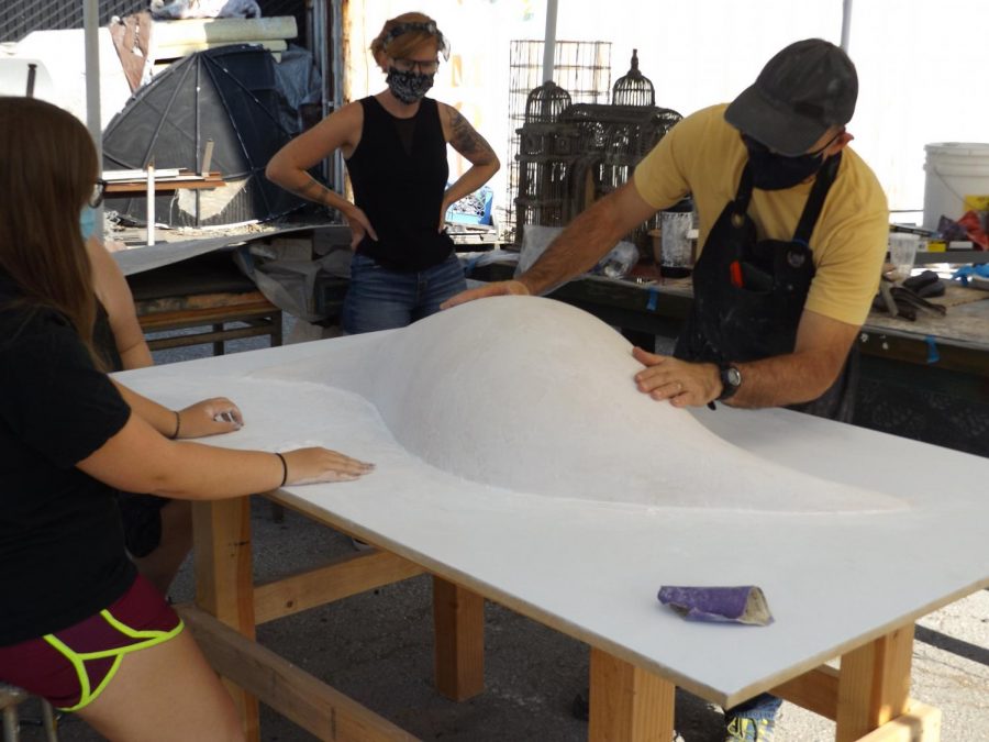 Professor Andrew Connelly inspects the mould for the small trial versions of a piece titled Tributary, at the Art Sculpture Lab, Thursday, Sept. 17, 2020. The full size piece is expected to be completed and installed near the new Welcome Center in fall 2021.