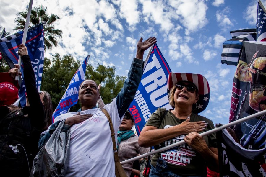 Chantay Ross (left) and other protestors sing to the closing lyrics of the United States national anthem at the California State Capitol on Saturday, Nov. 7, 2020, for a Trump rally calling for recounting votes in California and in battleground states. Ross states her cause for a recount due to not trusting the voting process. (Rahul Lal)