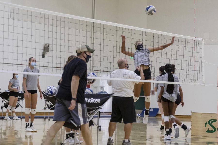Senior outside hitter Macey Hayden spikes the ball over the net during the Sac State volleyball team practice at Yosemite Hall at Sacramento State Wednesday, Oct. 21, 2020. All participants are required to wear a mask while at practice.