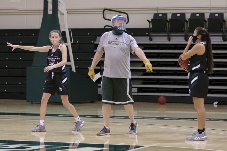Assistant Coach Bill Baxter, center, tells Milee Enger (1), left, and Jazmin Carrasco (4) where to go for this play during the women’s basketball team practice at The Nest at Sacramento State Tuesday, Oct. 27, 2020. The teams first game was scheduled for Monday, Nov. 30, 2020 was cancelled because of a possible coronavirus exposure.