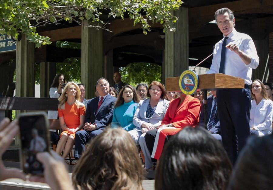 Gov. Gavin Newsom signs bills and then speaks to the assorted body of students and community about the Affordability Budget in the quad at City College on Monday, July 1, 2019. Gov. Gavin Newsom signs bills SB 76 Committee on Budget and Fiscal Review - Education finance, SB 77 Committee on Budget and Fiscal Review - Higher education trailer bill, and SB 93 Committee on Budget and Fiscal Review Budget Act of 2018: augmentation. (Sara Nevis for Sacramento City College’s The Express)