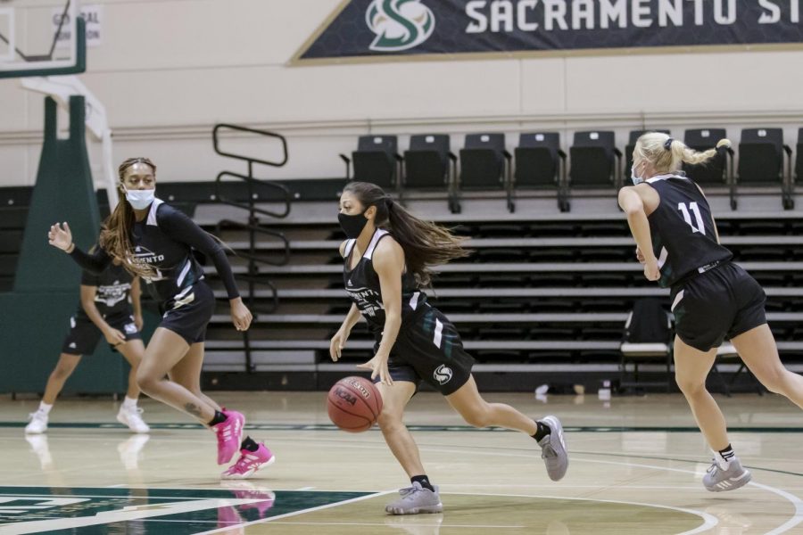 Jazmin Carrasco (4) dribbles the ball while she runs a play during the women’s basketball team practice at The Nest at Sacramento State Tuesday, Oct. 27, 2020. The matchup against UC Davis Tuesday, Dec. 8, 2020 has been canceled due to an update to the Yolo County health order.