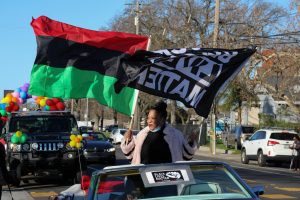 Tanya Faison, founder of BLM Sacramento, holding the BLM and Pan-Africa flag as she leads the Reclaim MLK  car caravan hosted by BLM Sacramento and NAACP Sacramento on Monday, Jan. 18, 2021. The caravan started at Grant High School then proceeded to Sacramento City College, then to Oak Park Community Center and ended at Sacramento State.