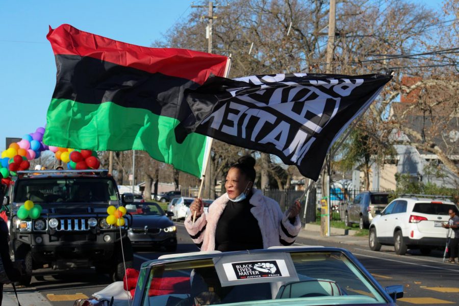 Tanya+Faison%2C+founder+of+BLM+Sacramento%2C+holding+the+BLM+and+Pan-Africa+flag+as+she+leads+the+Reclaim+MLK++car+caravan+hosted+by+BLM+Sacramento+and+NAACP+Sacramento+on+Monday%2C+Jan.+18%2C+2021.+The+caravan+started+at+Grant+High+School+then+proceeded+to+Sacramento+City+College%2C+then+to+Oak+Park+Community+Center+and+ended+at+Sacramento+State.