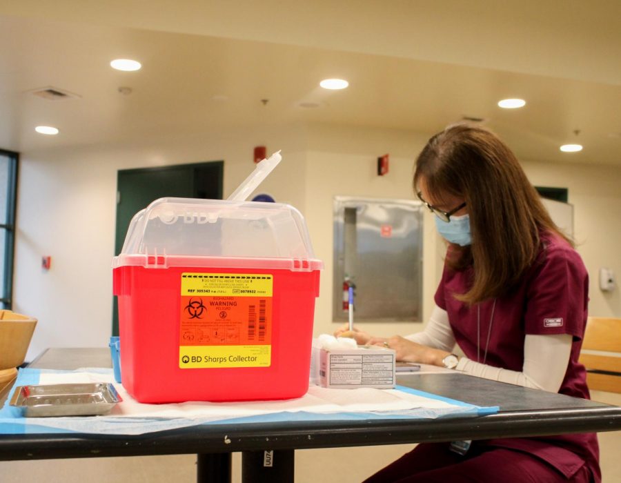 Catherine Nigro, registered nurse for the student health center, prepares for the first doses of the COVID-19 vaccine to be distributed to students and faculty in the in the Brown Bag room in the Union on Thursday, Jan. 28, 2021. They started preparing the vaccines at 8 a.m. and started distributing at 9 a.m.