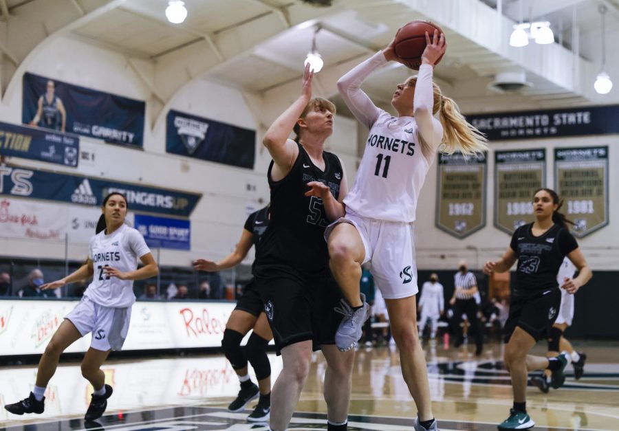 Sacramento State’s Summer Menke (11) goes up strong for a layup against Portland State’s Desirae Hansen (53) during the first quarter in the conference game at the Nest at Sac State in Sacramento, California, Saturday, Jan. 9, 2021. Menke had a double-double with 18 points and 11 rebounds.