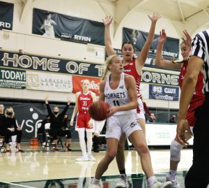 Sacramento States junior guard Summer Menke looks to pass the ball while getting double teamed on the baseline in a game at the Nest against Southern Utah on Thursday, Feb. 18, 2021. Menke had a double-double with 22 points and 12 rebounds.