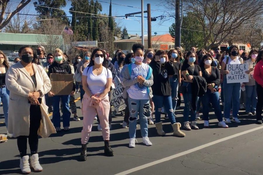 Students, parents, and alumni of St. Francis High School gather in protest on Wednesday Feb 24, 2021 against the school's retention of a student who recently shared a photo of herself wearing blackface on Snapchat. As of Wednesday, the student is no longer attending the all-women's Catholic high school. 