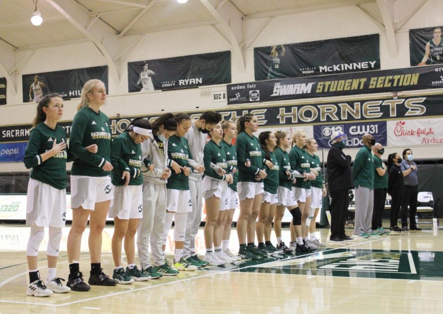 Sac State womens basketball team
 lined up together, interlocking arms during the national anthem on Jan. 28, 2021. The Hornets are 1-13 overall and 1-9 in the Big Sky conference. 