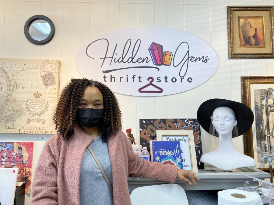 Passion Bailey, co-owner of Hidden Gems Thrift Store, poses for a photo behind the counter Saturday, Feb. 6, 2021. The store is located Florin Square, which acts as a hub for Black-owned businesses. 