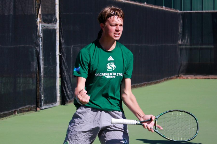 Freshman Liam Liles celebrates after scoring in the first set of his doubles matchup at the campus tennis courts Friday, Feb. 12. The Hornets fell to the Mustangs 4-0.