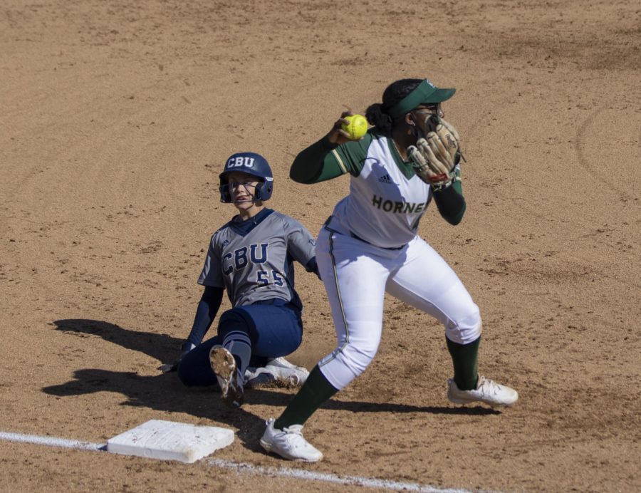 Sacramento State sophomore Lewa Day (44), third base, gets California Baptist University’s Maile Olsen (55) out atnd third and tries to turn a double play with a throw to first base in the top of the second inning during the NorCal Kickoff in game one of the doubleheader at Shea Stadium at Sac State, Friday, Feb. 12, 2021. Day had two at bat with one hit and one RBI.