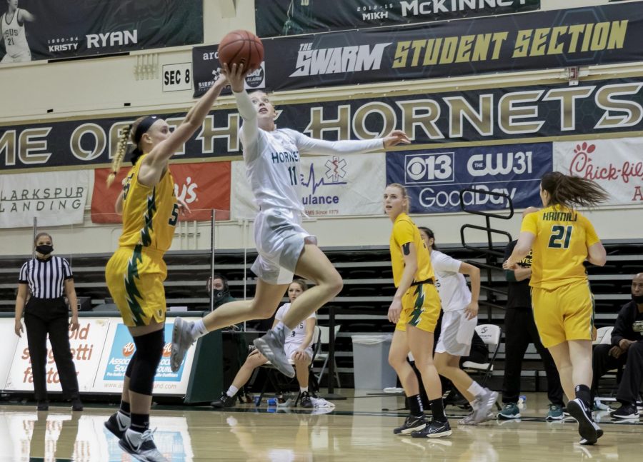 Sacramento State’s Summer Menke (11) attempts a layup past University of San Francisco’s Abby Rathbun (55) during the fourth quarter in the game at the Nest at Sac State Tuesday, Dec. 22, 2020.  The Hornets played Northern Arizona University Saturday and Menke had 12 points and nine rebounds but Sac State lost and moved to 1-14,1-11 Big Sky.